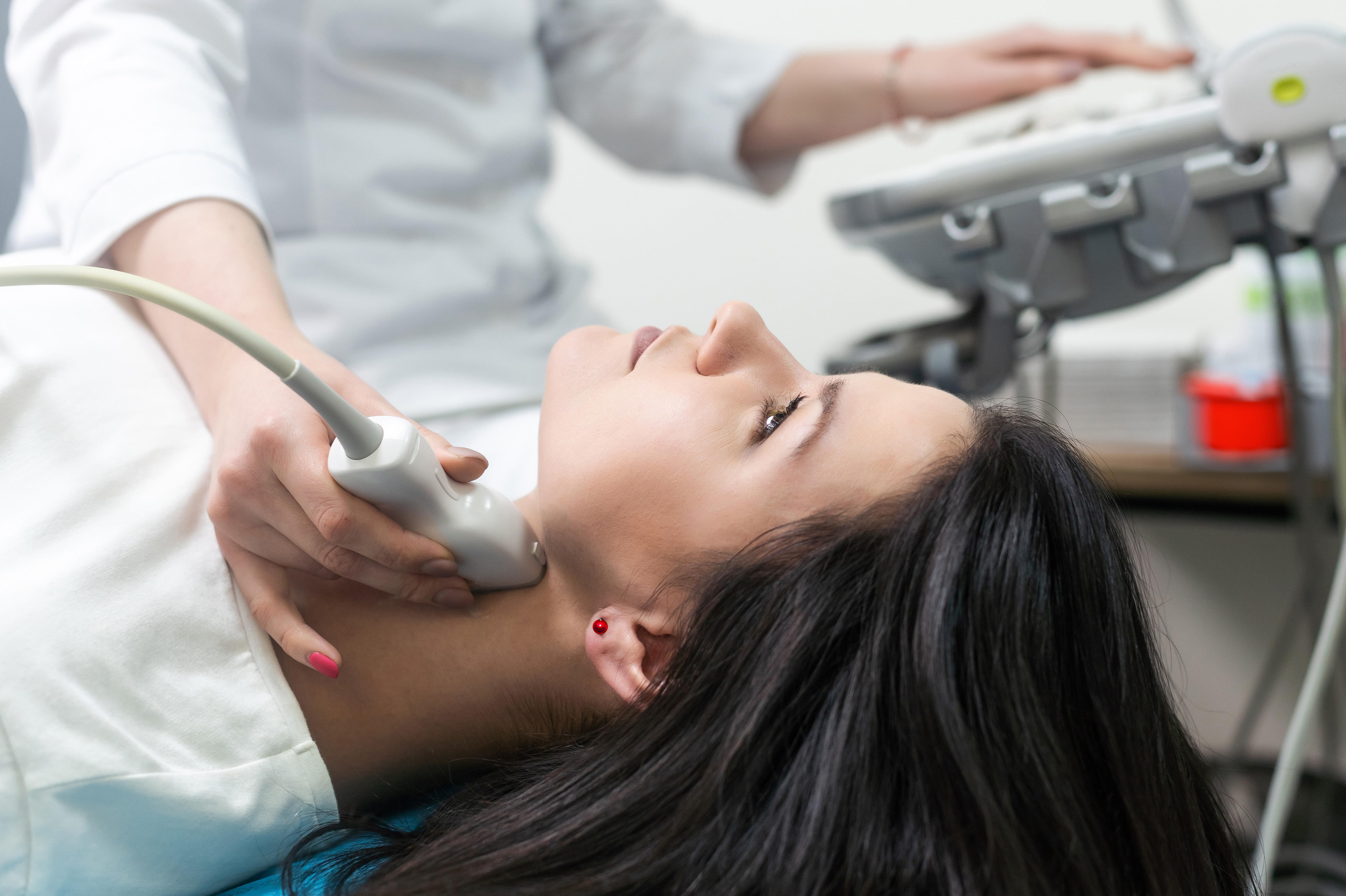 Woman receiving a thyroid scan