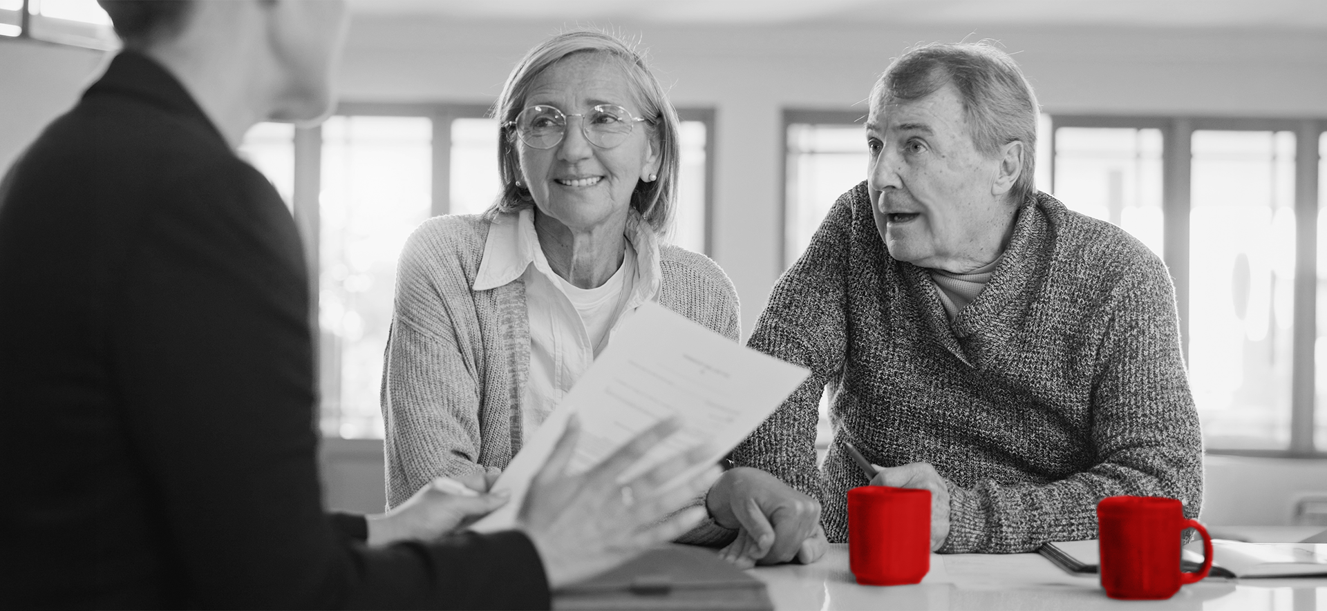 An elderly couple speaking with a financial advisor