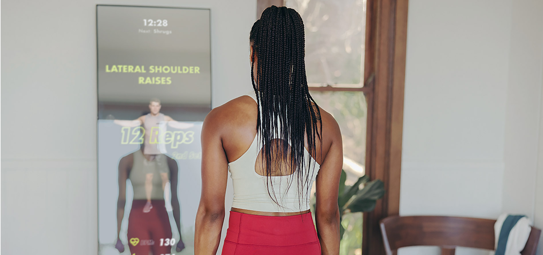 Woman exercising at smart mirror