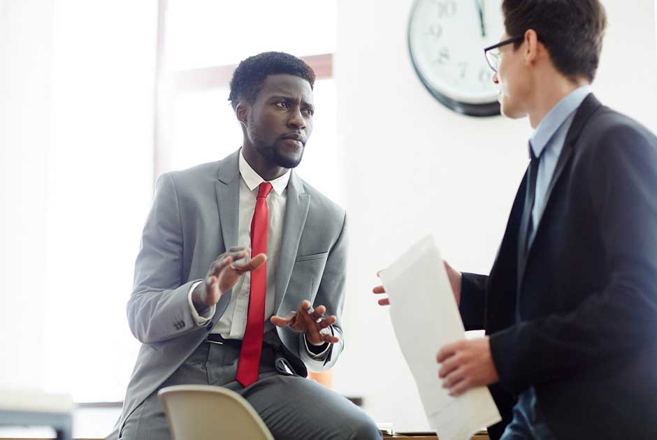 A diverse pair of executives discuss a funded re arrangement