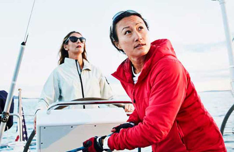 A sailor in a red slicker looks to the horizon, representing the underwriting guidelines provided by the Global Underwriting Manual