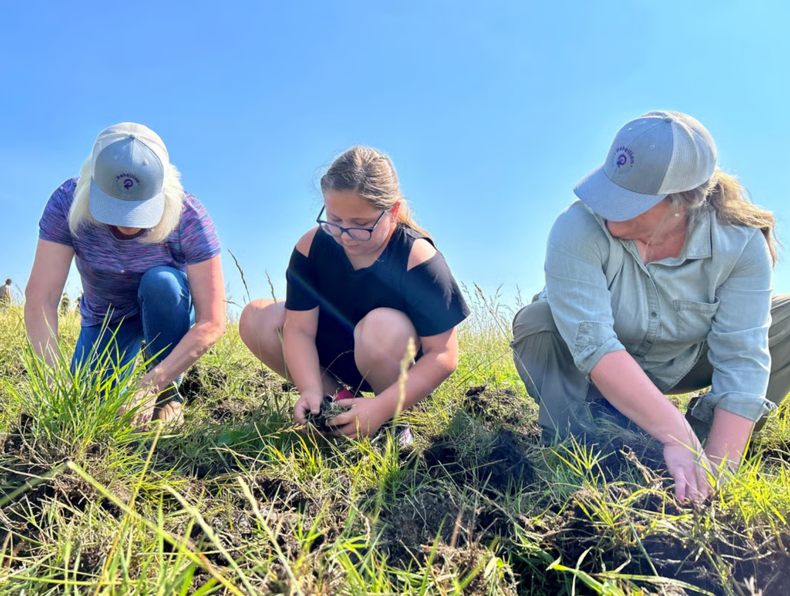3 volunteers at the Heartland land restoration site