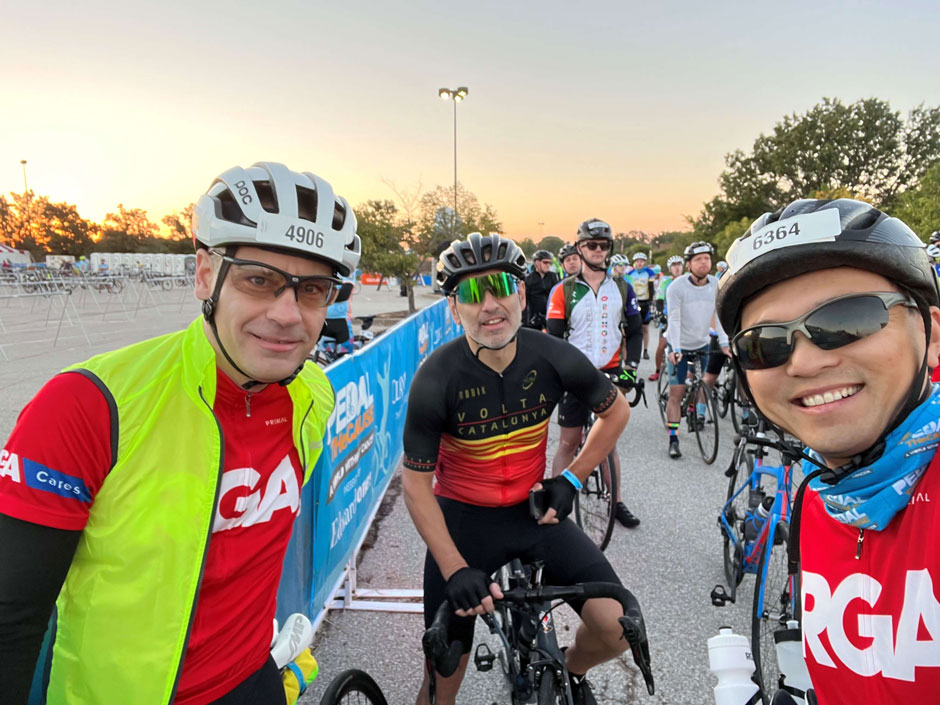 Employees on bikes pose after completing a charity event