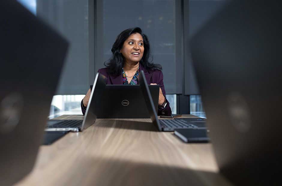 A decision-maker at the head of the table, the room's attention turned her way — capital structured deliberately, not by default.