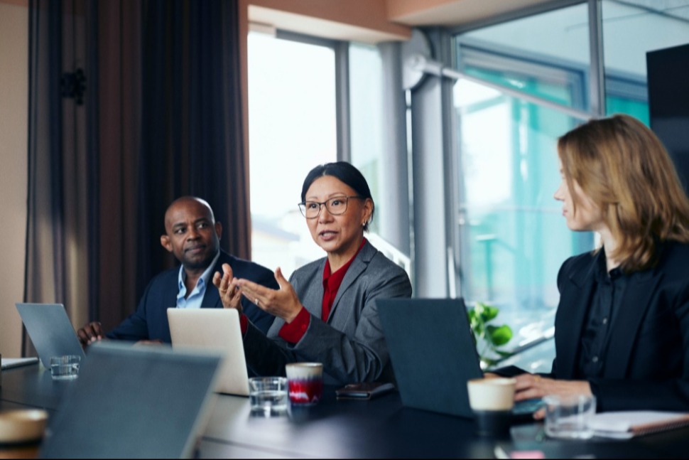 Colleagues work a deal across one table — the local regulatory knowledge RGA brings to each market it enters