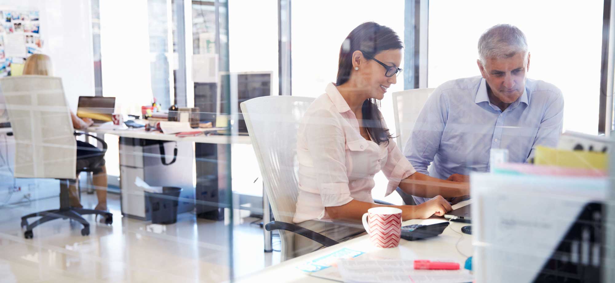 A pair of claims assessors collaborate on a case