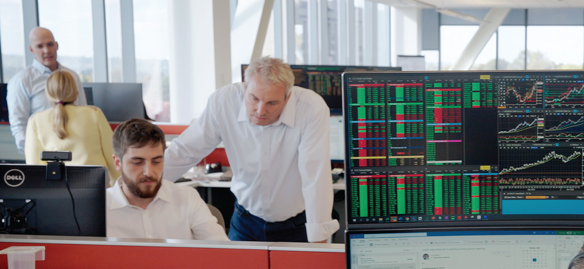 Bond traders gather around a trading desk