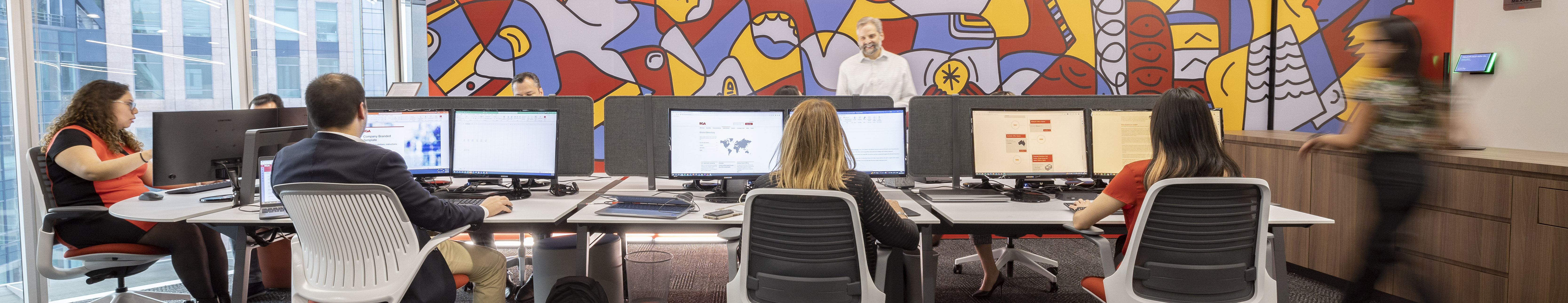 A busy Mexico City headerquarters featuring people in discussion.