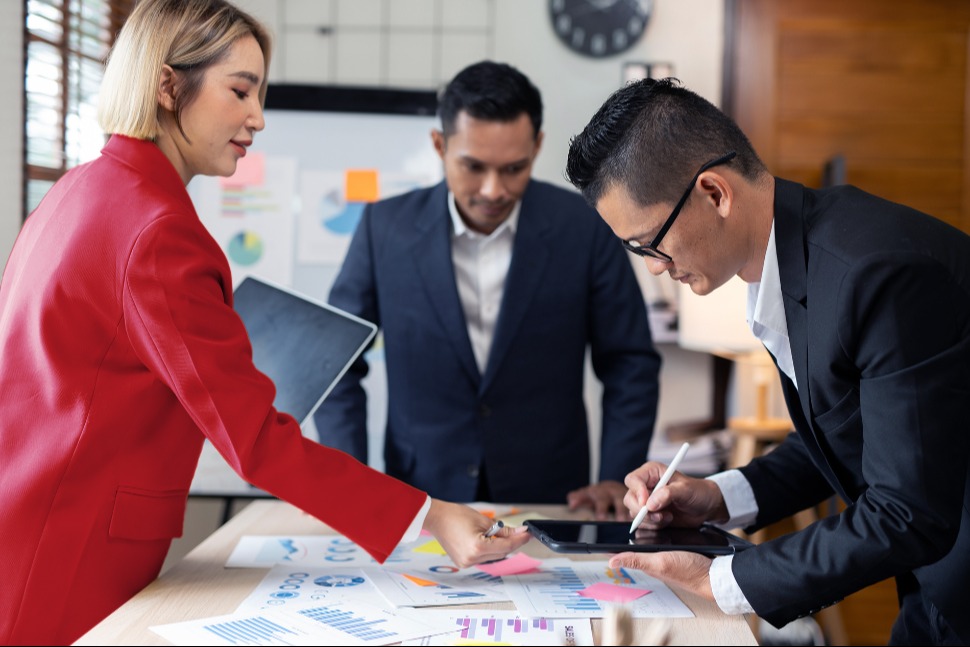 A group of colleagues discuss performance of products