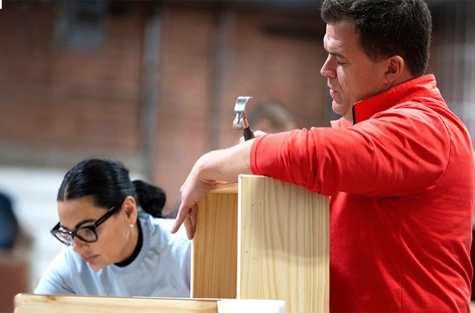 RGA employees assembling wooden dressers during a community service project.