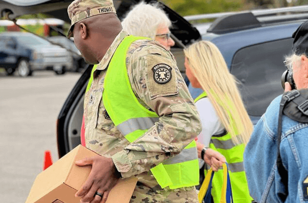 RGA employees assist the U.S. National Guard in distributing food following a natural disaster