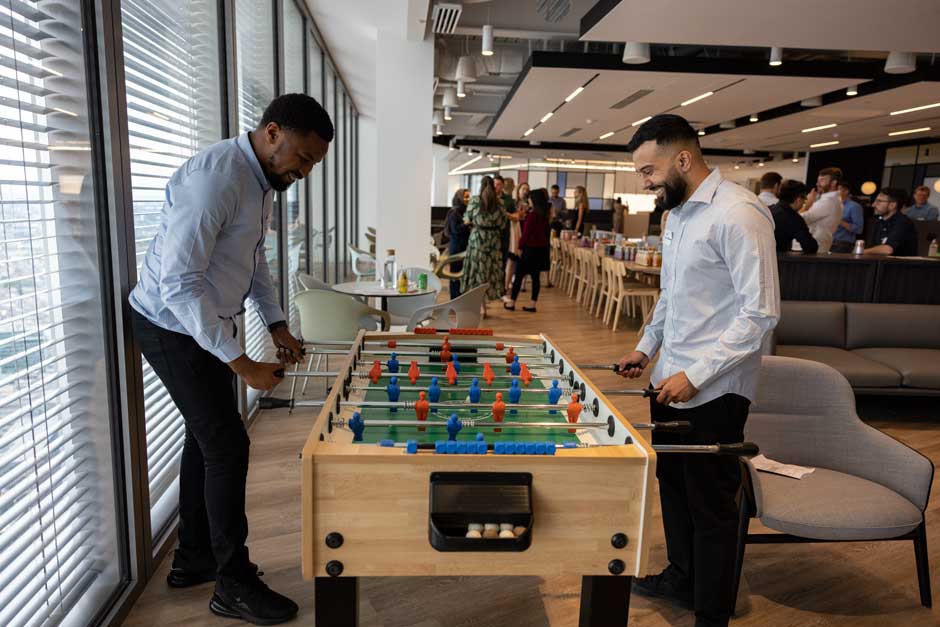 A pair of RGA UK employees play a lively game of foosball