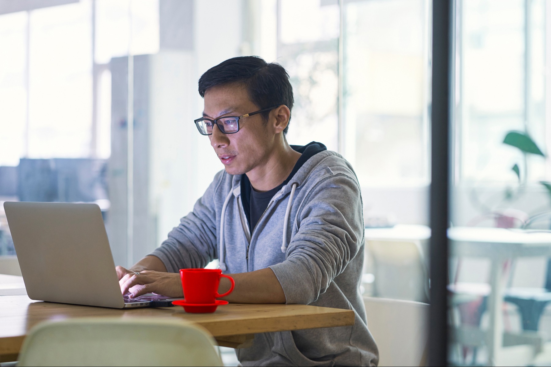 A man focuses intently on analytics on a laptop