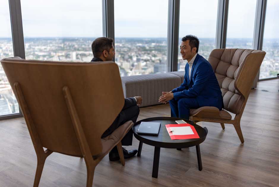 A pair of investment executives chat in RGA's London, U.K. office.