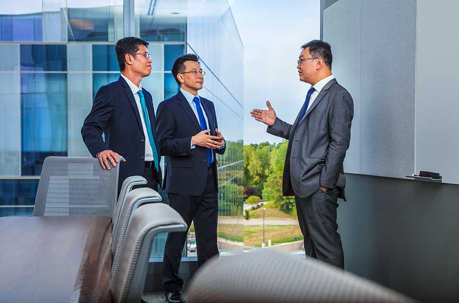 A group of Southeast Asia executives discuss in a conference room