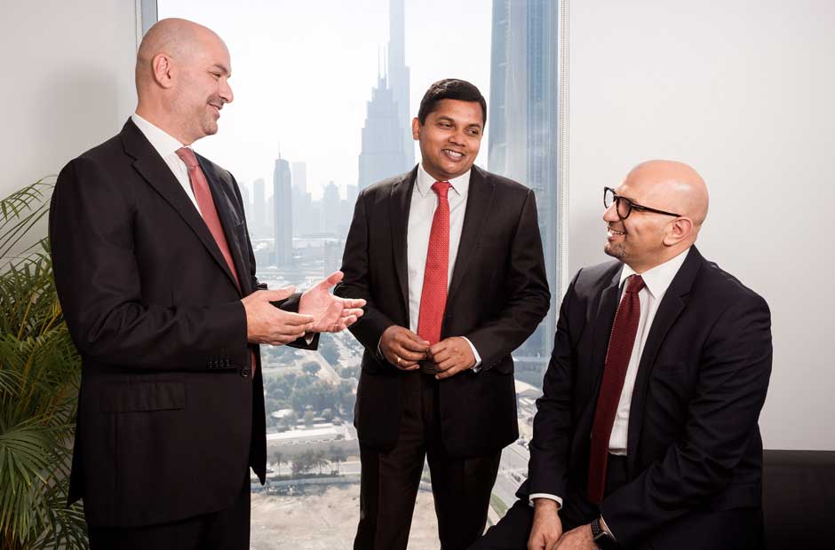 A trio of RGA leaders consult from the company's offices in Dubai