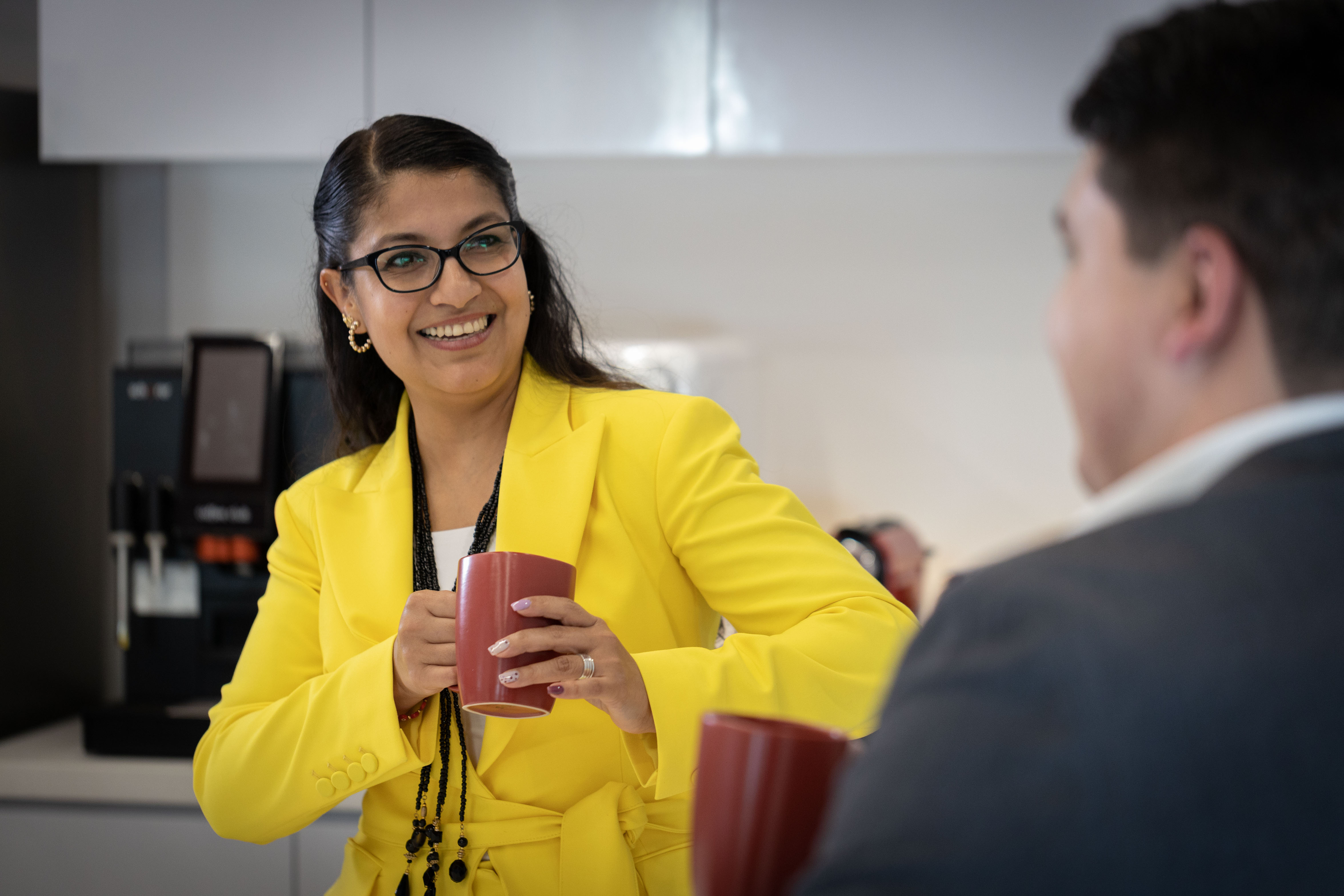 A businessman and a woman discuss business.