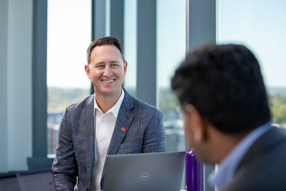 RGA underwriting employee smiling in a meeting