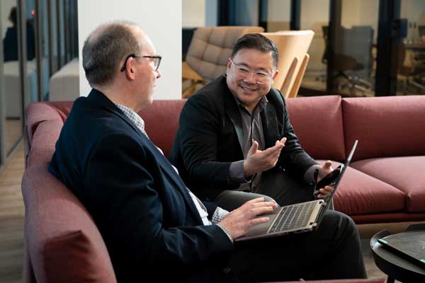 A pair of RGA executives chat animatedly about medical underwriting topics