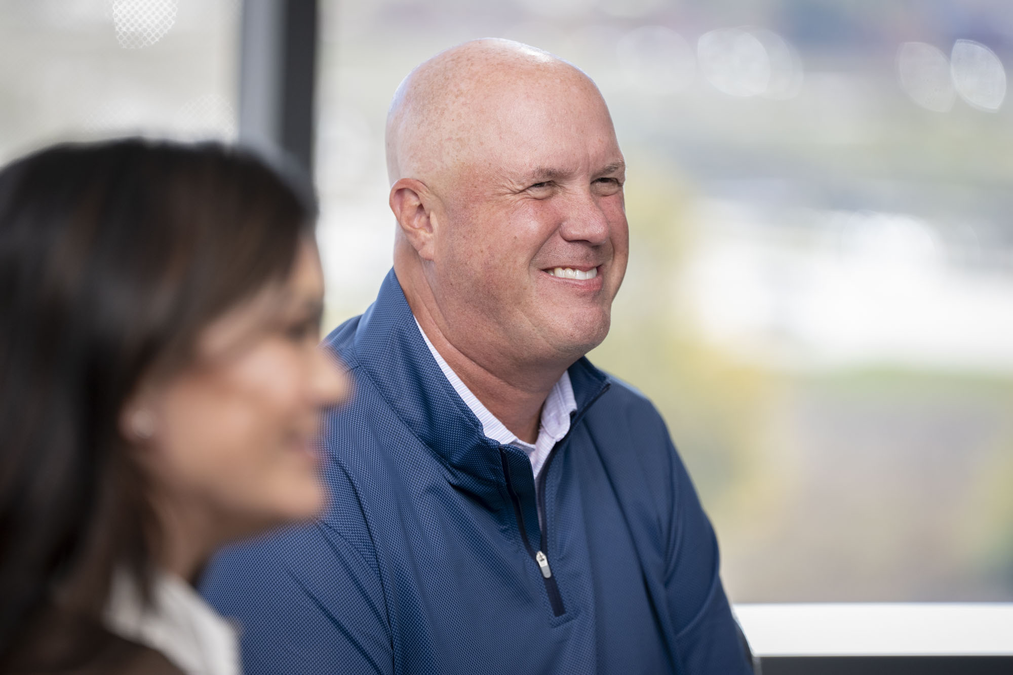 Image of RGA's Executive Vice President, Head of the Americas, Ron Herman in a meeting, seated near a large window with a blurred outdoor view in the background.