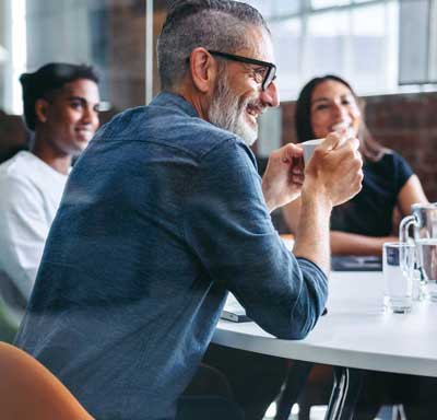 A group of executives gather around a table, brainstorming