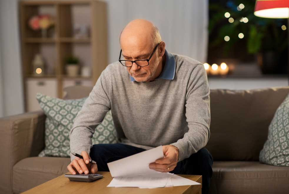 An older man reviews his annuity premiums