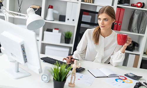 Woman at desk with coffee cup