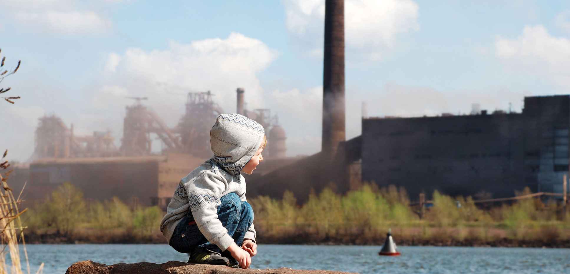 Boy in front of a factory