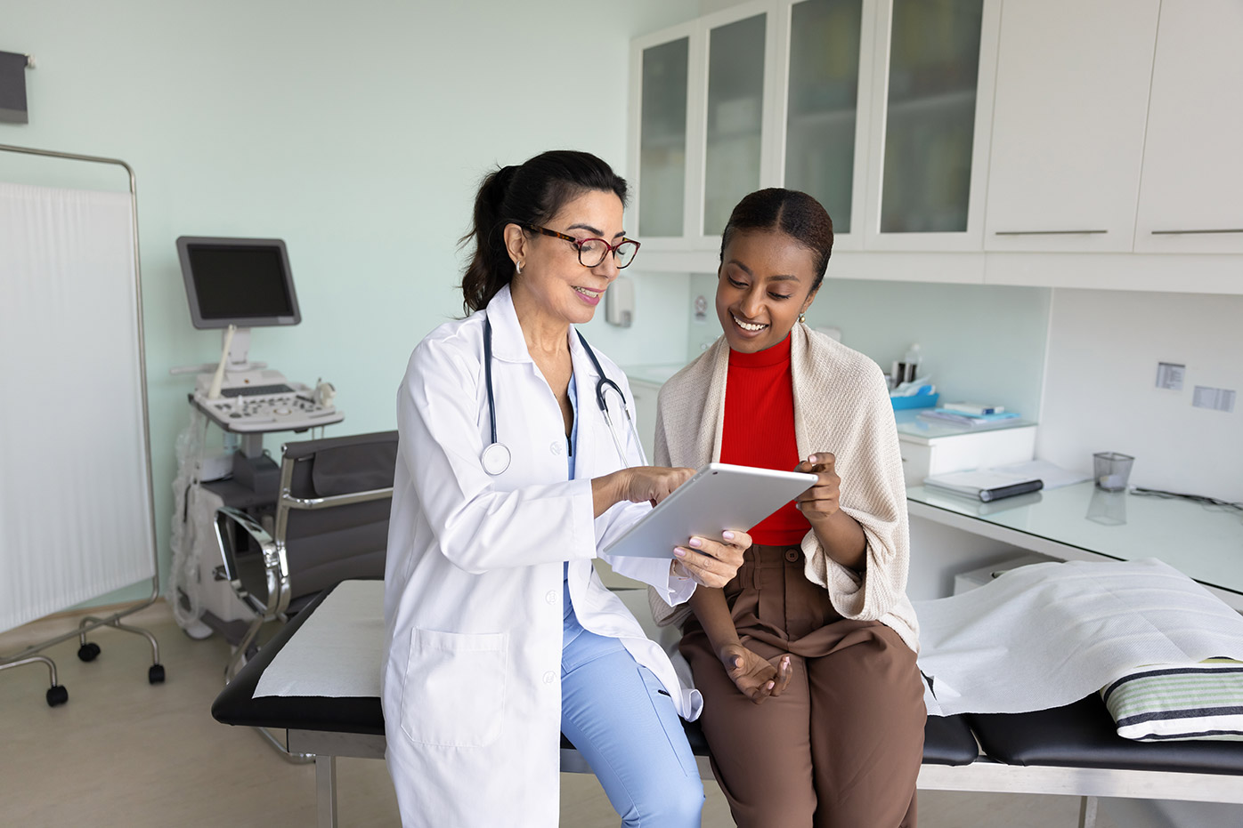 Doctor and patient looking at a tablet