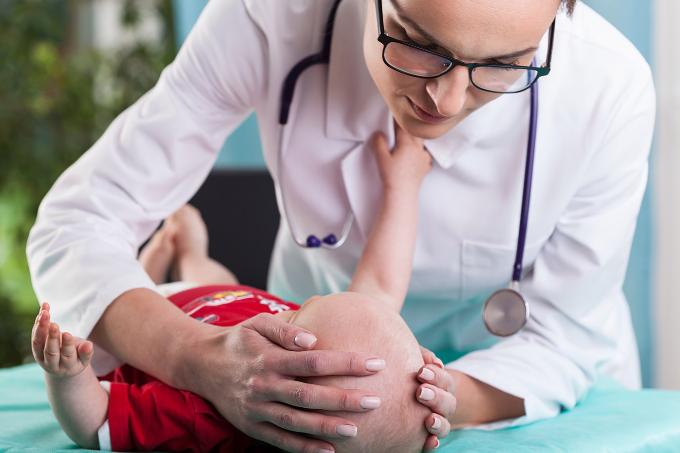Doctor examining a newborn