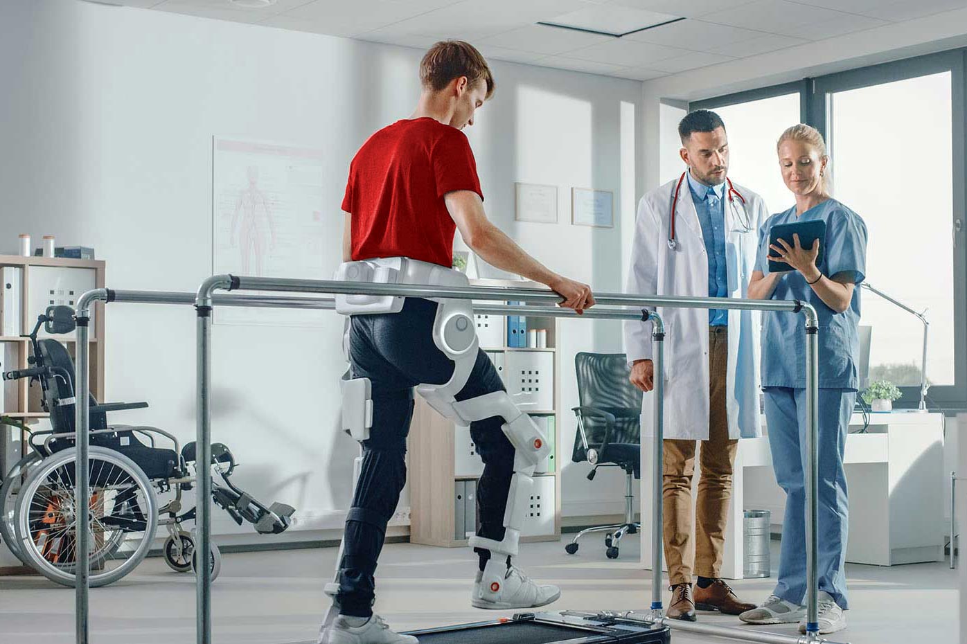 Doctors heling a physical rehab patient