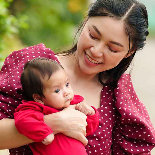Asian woman holding her baby