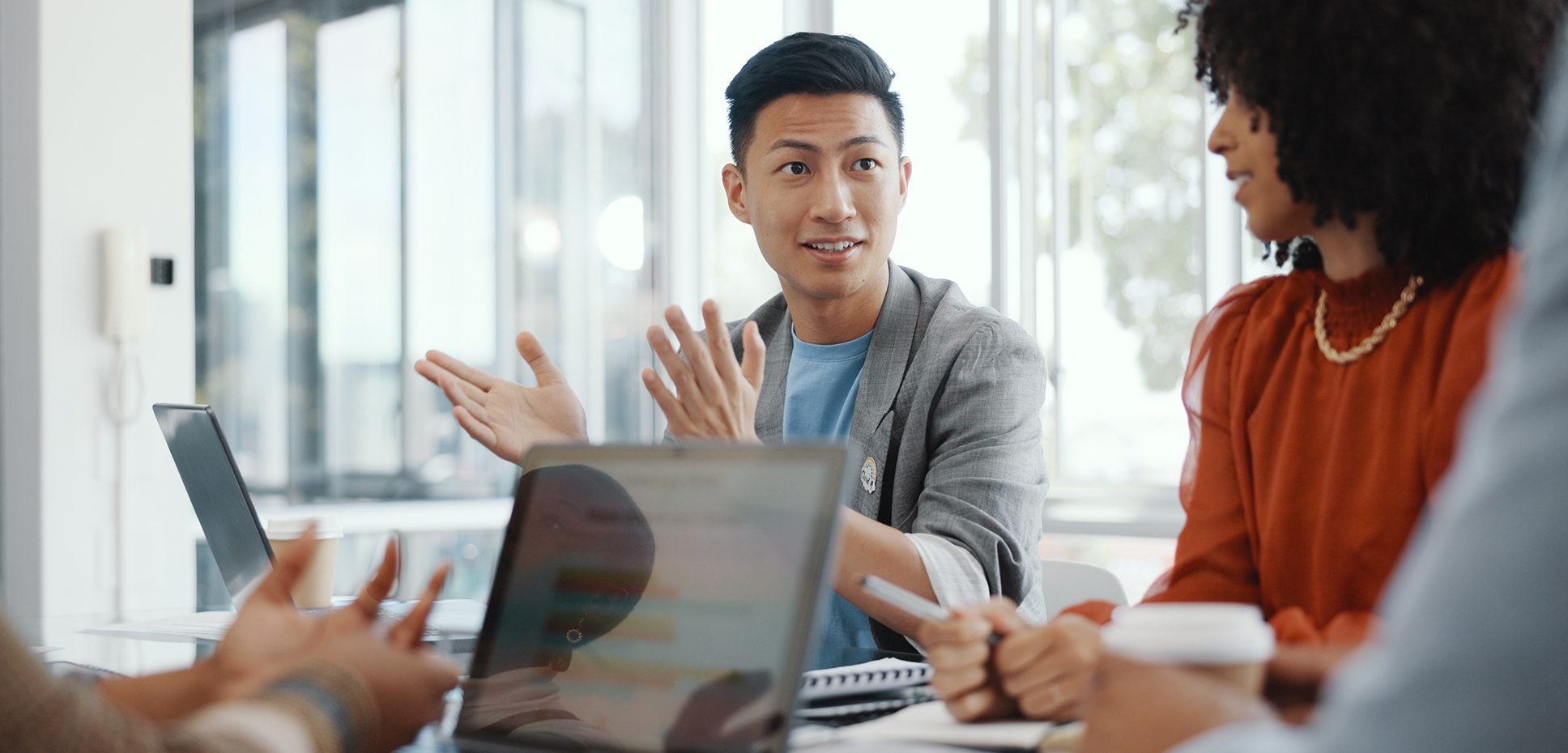 A man gestures in a meeting