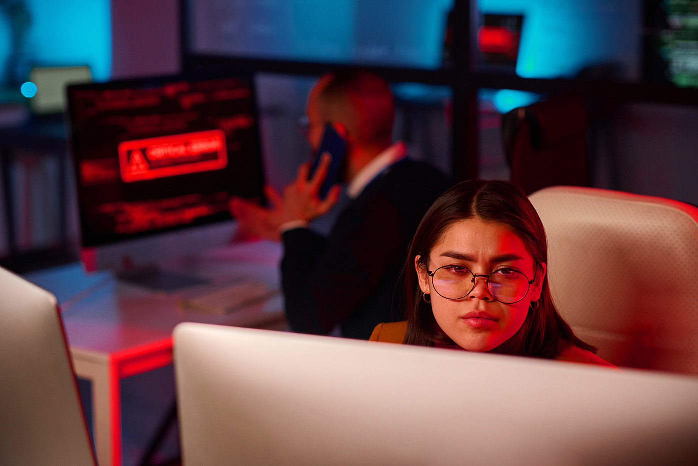 Girl looking at computer monitor flashing red