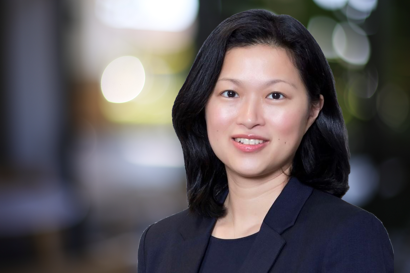 Profile of Queenie Choi, superimposed on office backdrop.