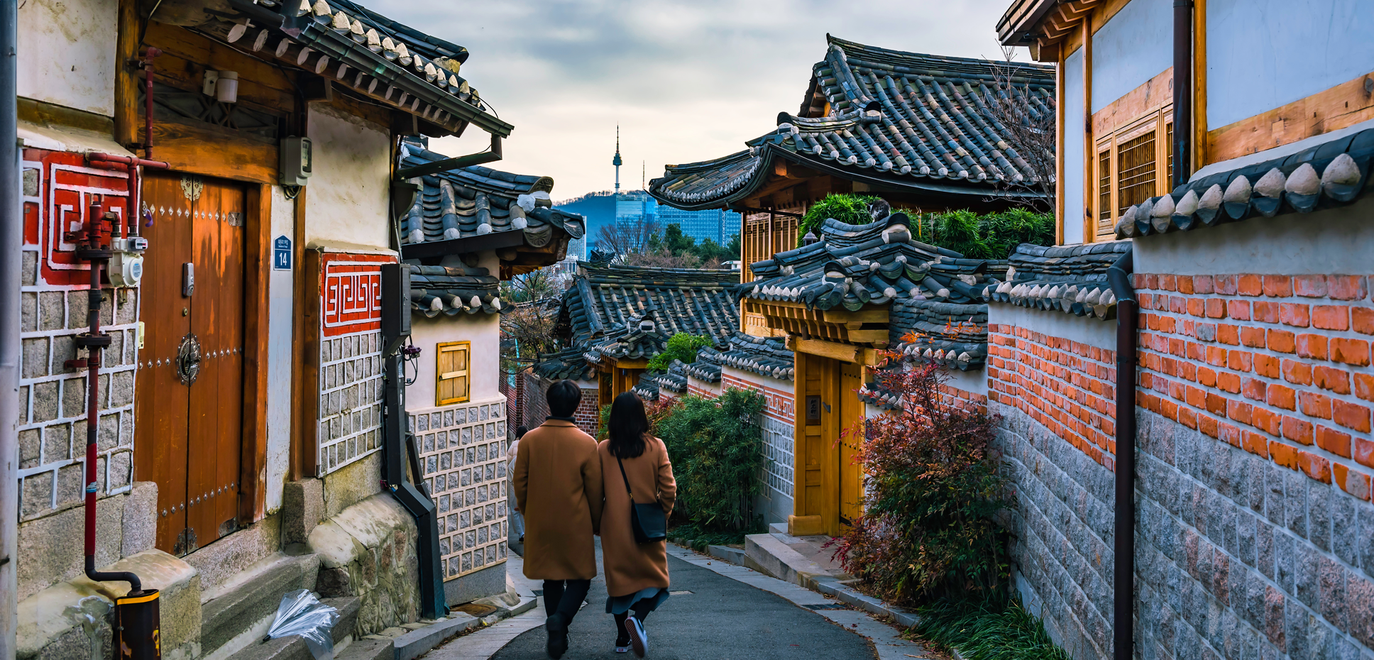 A couple walks through historic Bukchon Hanok Village in Seoul