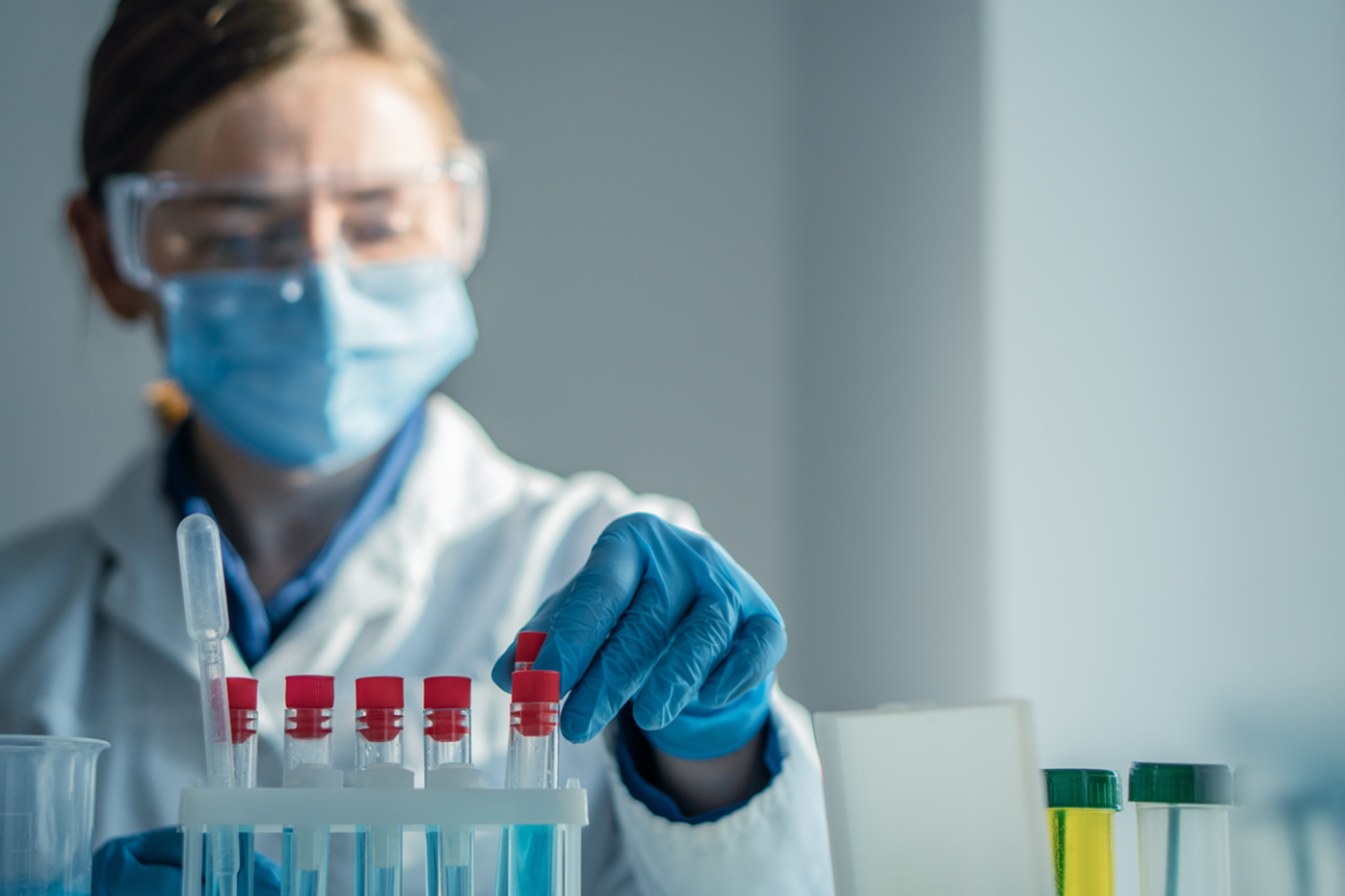 Lab technician with test tubes