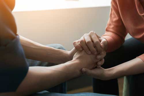 A counselor comforts someone experiencing mental health crisis