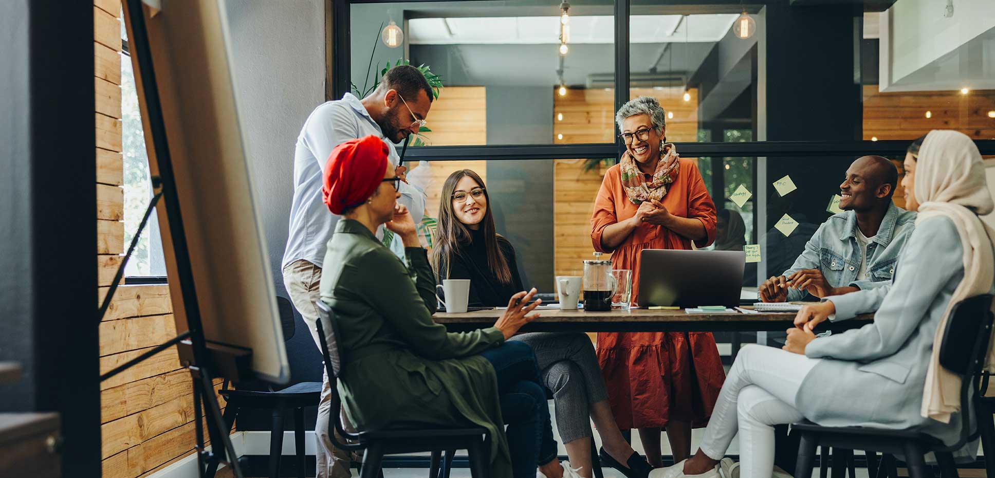 Six office workers in the Middle East wroking around a table