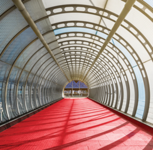 Red road through light filled tunnel