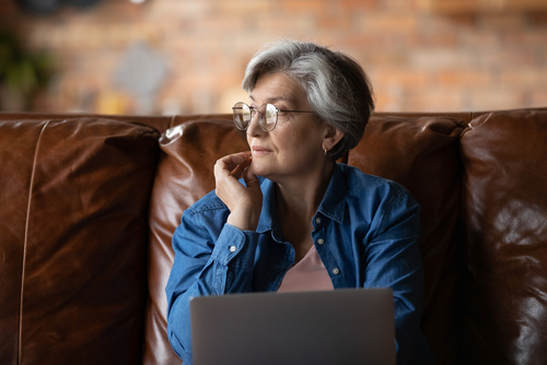 An older woman looks pensively into the distance