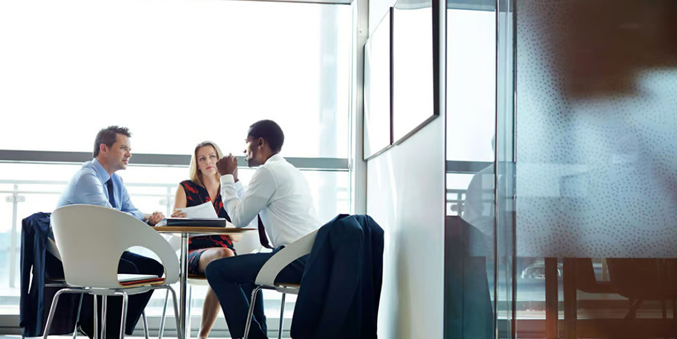 People talking at an office table