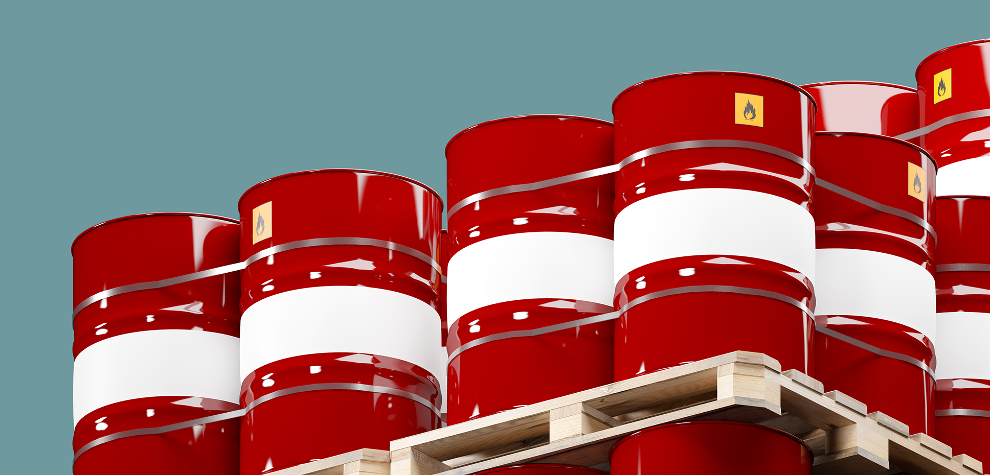 A large group of red barrels holding chemicals are stacked on pallets
