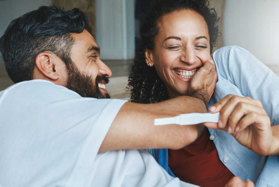 A couple excitedly view a postiive pregnancy test