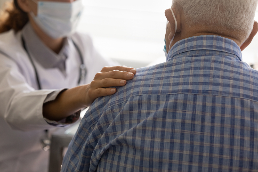 Preventative care with elderly masked man visiting hospital