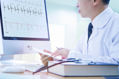 Doctor analyzes EKG results
