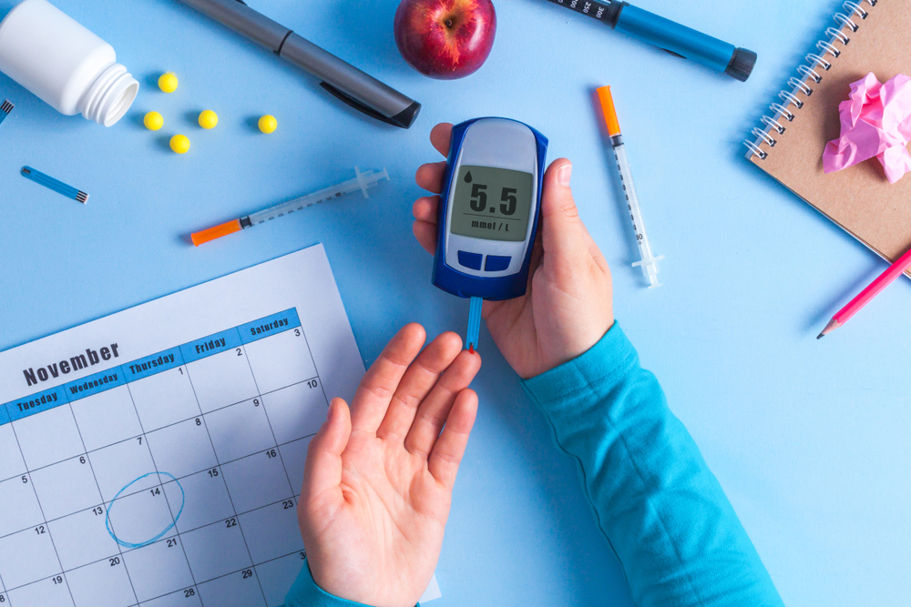 Diabetic sticks finger to measure blood sugar