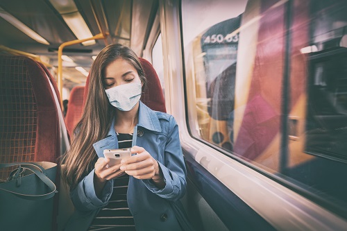 Masked woman in transit