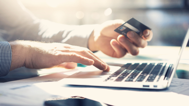 Digital Banking image of individual using a credit card to make a purchase