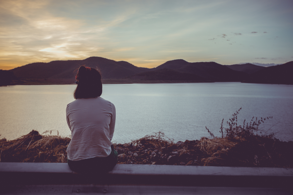 Forlorn figure looking at sunset